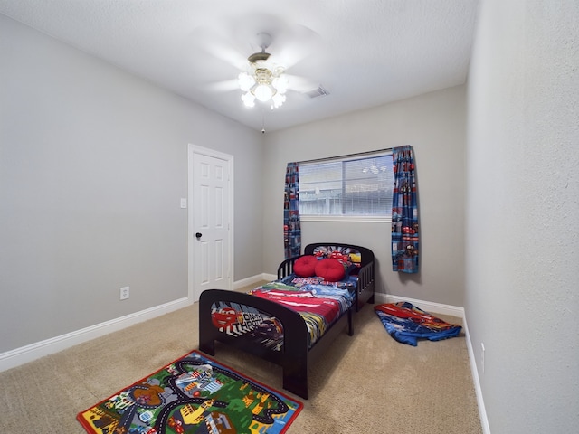 11614 Taos Ln, Houston, TX 77070 - carpeted bedroom with baseboards and a ceiling fan