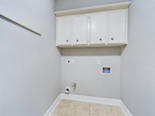 11614 Taos Ln, Houston, TX 77070 - washroom with electric dryer hookup, gas dryer hookup, hookup for a washing machine, tile patterned floors, and cabinet space