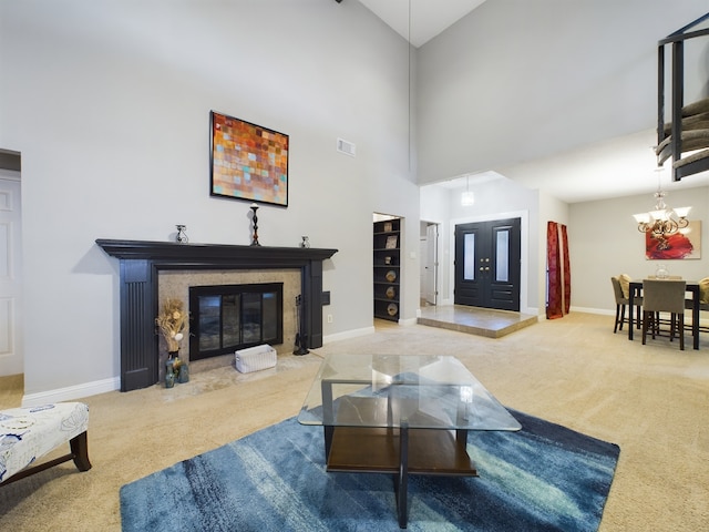 11614 Taos Ln, Houston, TX 77070 - carpeted living area featuring a fireplace with flush hearth, a chandelier, and a towering ceiling