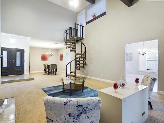 11614 Taos Ln, Houston, TX 77070 - living room with a towering ceiling, a chandelier, stairs, and carpet floors