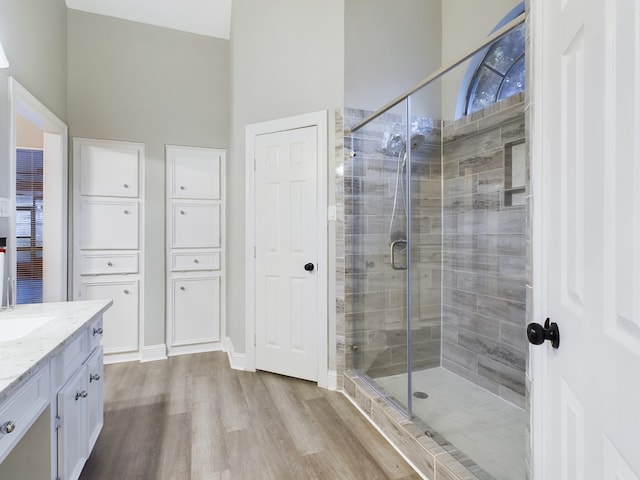 11614 Taos Ln, Houston, TX 77070 - full bath featuring wood finished floors, vanity, a stall shower, and a high ceiling