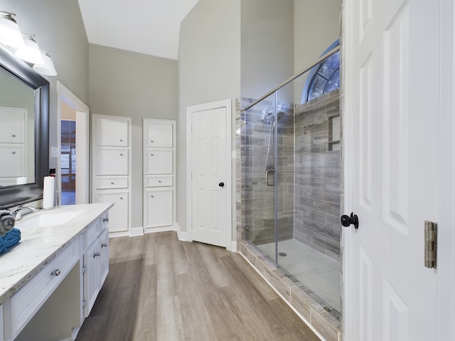 11614 Taos Ln, Houston, TX 77070 - full bathroom featuring vanity, wood finished floors, a shower stall, and high vaulted ceiling