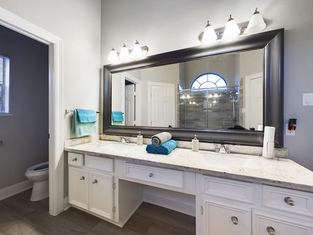 11614 Taos Ln, Houston, TX 77070 - bathroom with double vanity, a stall shower, and wood finished floors