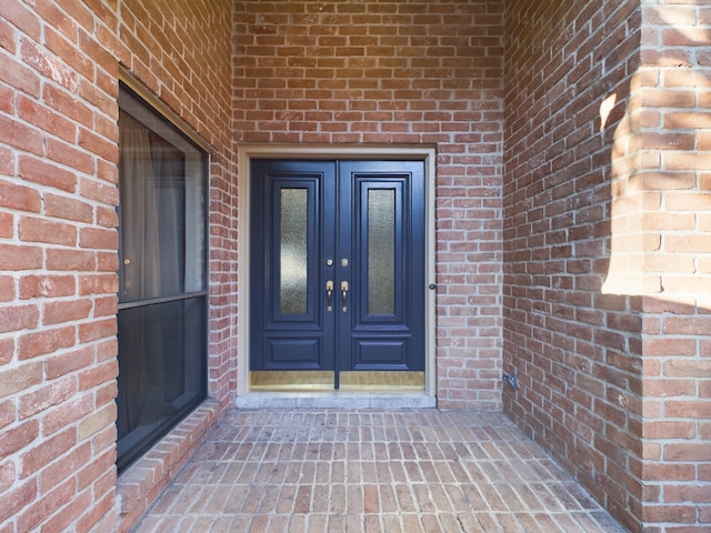 11614 Taos Ln, Houston, TX 77070 - view of exterior entry with brick siding and french doors