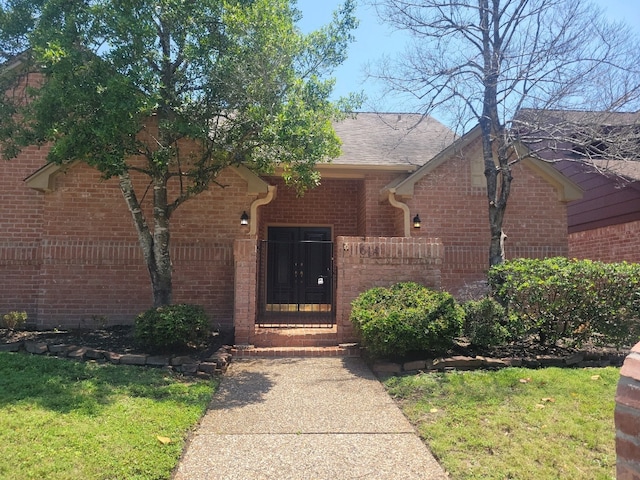 11614 Taos Ln, Houston, TX 77070 - entrance to property featuring brick siding and a lawn