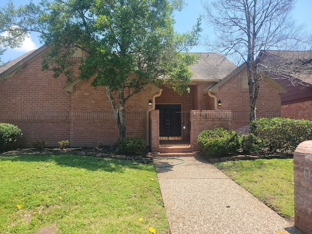 11614 Taos Ln, Houston, TX 77070 - view of front of house with brick siding and a front lawn