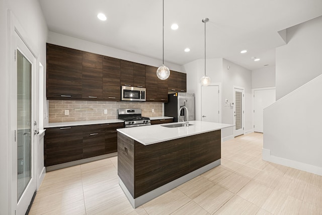 1907 Harlem St Unit A, Houston, TX 77020 - kitchen featuring stainless steel appliances, light countertops, backsplash, dark brown cabinets, and a kitchen island with sink