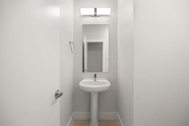 1907 Harlem St Unit A, Houston, TX 77020 - bathroom with baseboards and wood finished floors