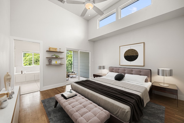1907 Harlem St Unit A, Houston, TX 77020 - bedroom featuring multiple windows, a high ceiling, wood finished floors, and connected bathroom