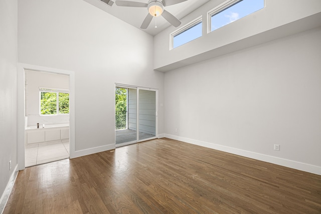 1907 Harlem St Unit A, Houston, TX 77020 - spare room featuring plenty of natural light, a towering ceiling, wood finished floors, and a ceiling fan