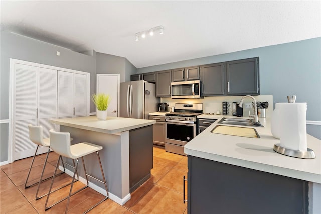 1710 Blue Heather Ln, Fresno, TX 77545 - kitchen with stainless steel appliances, light tile patterned floors, a kitchen breakfast bar, a kitchen island, and light countertops