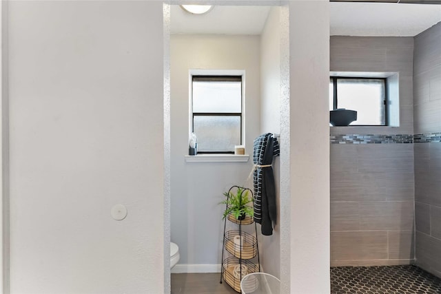 1710 Blue Heather Ln, Fresno, TX 77545 - bathroom featuring a tile shower and toilet