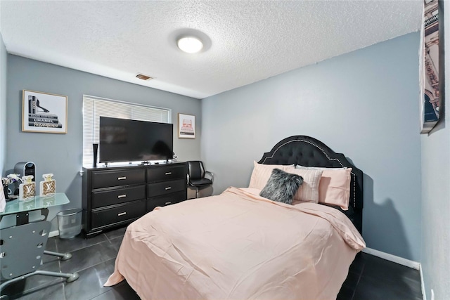 1710 Blue Heather Ln, Fresno, TX 77545 - bedroom with a textured ceiling and dark tile patterned floors