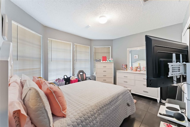 1710 Blue Heather Ln, Fresno, TX 77545 - bedroom with a textured ceiling and dark tile patterned flooring