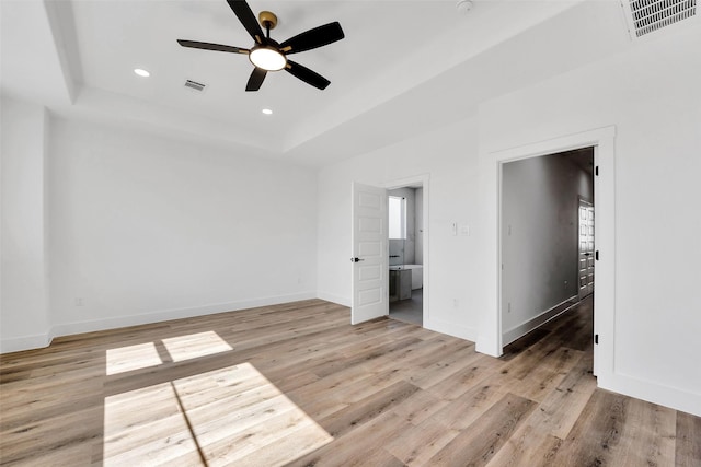 1805 Emir St Unit E, Houston, TX 77009 - empty room with a tray ceiling, a ceiling fan, light wood-style floors, and recessed lighting