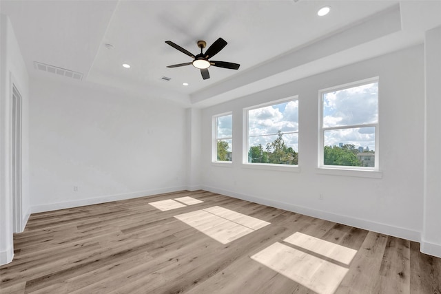 1805 Emir St Unit E, Houston, TX 77009 - empty room featuring a raised ceiling, light wood-style floors, a ceiling fan, and recessed lighting