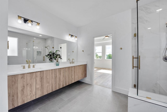 1805 Emir St Unit E, Houston, TX 77009 - bathroom with double vanity, a shower stall, ceiling fan, and tile patterned floors