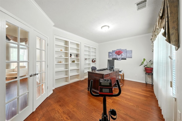 21306 Willowford Park Dr, Katy, TX 77450 - office space with crown molding, built in shelves, wood finished floors, and french doors
