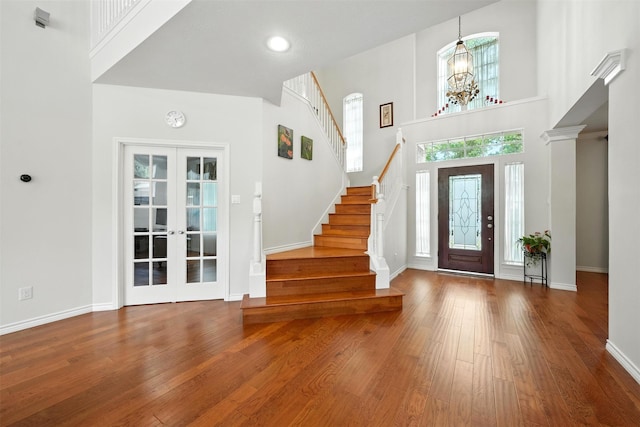 21306 Willowford Park Dr, Katy, TX 77450 - entryway with a towering ceiling, stairs, wood finished floors, and french doors