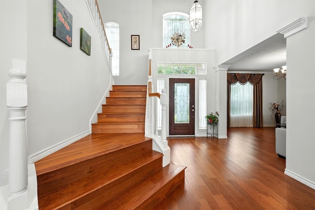 21306 Willowford Park Dr, Katy, TX 77450 - foyer featuring a chandelier, stairs, wood finished floors, and a towering ceiling