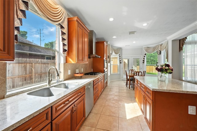21306 Willowford Park Dr, Katy, TX 77450 - kitchen with wall chimney range hood, appliances with stainless steel finishes, brown cabinets, decorative backsplash, and recessed lighting