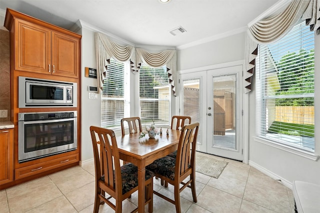21306 Willowford Park Dr, Katy, TX 77450 - dining room with ornamental molding, light tile patterned flooring, plenty of natural light, and french doors