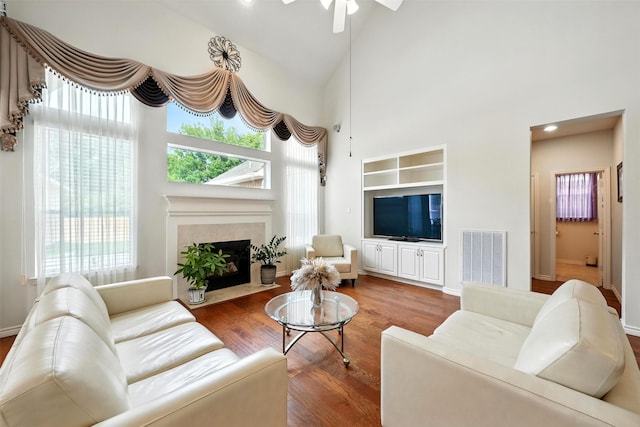 21306 Willowford Park Dr, Katy, TX 77450 - living room featuring plenty of natural light, a fireplace, a ceiling fan, and a high ceiling