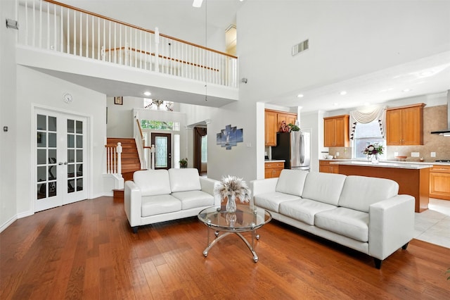 21306 Willowford Park Dr, Katy, TX 77450 - living area with a towering ceiling, french doors, wood finished floors, recessed lighting, and stairway