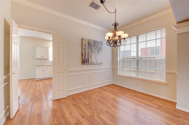 21306 Branford Hills Ln, Katy, TX 77450 - unfurnished dining area with light wood finished floors, crown molding, and a chandelier