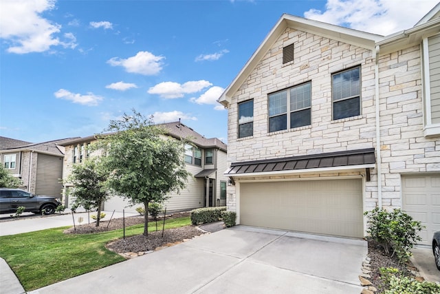 16114 Northern Cardinal Ln, Cypress, TX 77433 - view of front of home featuring stone siding, driveway, a standing seam roof, an attached garage, and a metal roof