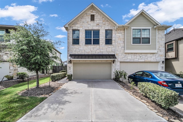 16114 Northern Cardinal Ln, Cypress, TX 77433 - view of front of property featuring a garage, concrete driveway, stone siding, a standing seam roof, and a metal roof