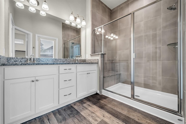 16114 Northern Cardinal Ln, Cypress, TX 77433 - full bath featuring double vanity, a stall shower, and wood finished floors