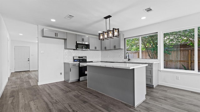 8603 Twisting Vine Ln, Houston, TX 77040 - kitchen with gray cabinetry, appliances with stainless steel finishes, dark wood finished floors, and recessed lighting