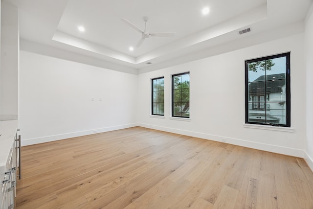 1310 Willard, Houston, TX 77006 - spare room featuring a tray ceiling, ceiling fan, light wood-style floors, and recessed lighting
