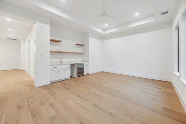 1310 Willard, Houston, TX 77006 - unfurnished living room with beverage cooler, wet bar, a ceiling fan, light wood-style floors, and recessed lighting