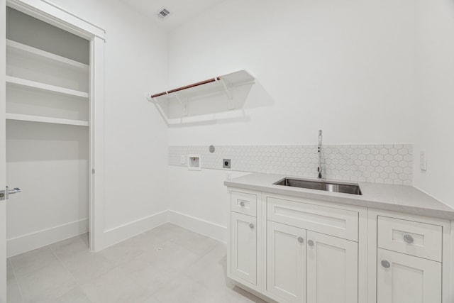 1310 Willard, Houston, TX 77006 - washroom featuring electric dryer hookup, hookup for a washing machine, and cabinet space