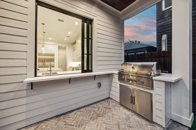 1310 Willard, Houston, TX 77006 - patio terrace at dusk with exterior kitchen and a sink