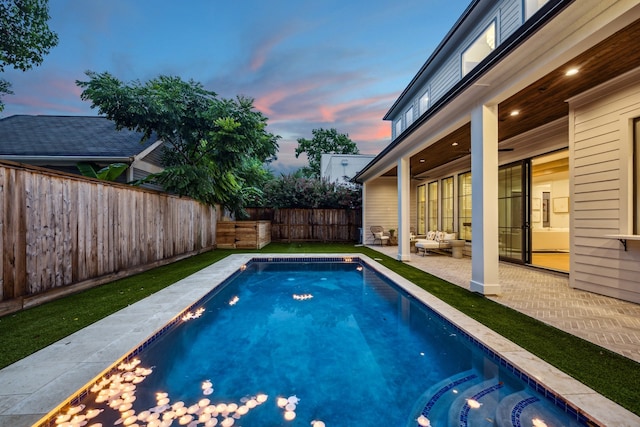 1310 Willard, Houston, TX 77006 - pool at dusk with a patio area, a fenced backyard, and an outdoor hangout area