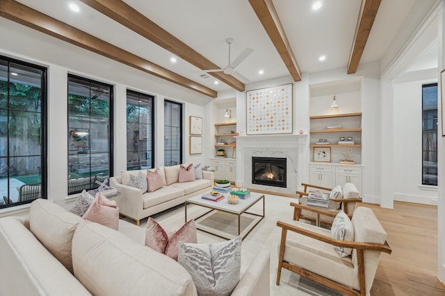 1310 Willard, Houston, TX 77006 - living room featuring a ceiling fan, a glass covered fireplace, light wood-style floors, beam ceiling, and recessed lighting