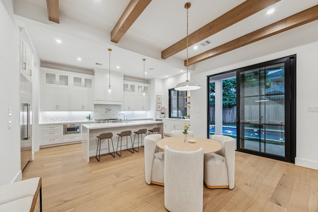 1310 Willard, Houston, TX 77006 - dining space featuring light wood-style floors, beam ceiling, and recessed lighting