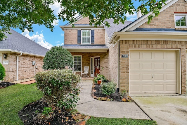 28123 Canyon Wren Dr, Katy, TX 77494 - traditional home featuring covered porch, concrete driveway, a shingled roof, brick siding, and a garage