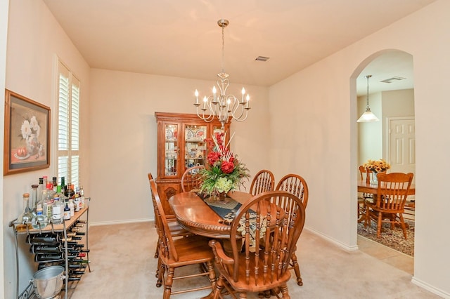 28123 Canyon Wren Dr, Katy, TX 77494 - dining space with light colored carpet, arched walkways, and a chandelier