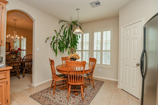 28123 Canyon Wren Dr, Katy, TX 77494 - dining space featuring arched walkways, light tile patterned flooring, and a chandelier