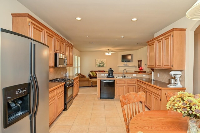 28123 Canyon Wren Dr, Katy, TX 77494 - kitchen with black appliances, recessed lighting, open floor plan, a peninsula, and light tile patterned floors