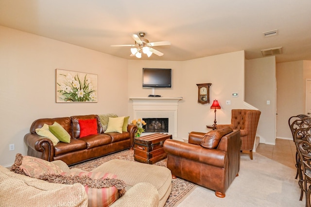 28123 Canyon Wren Dr, Katy, TX 77494 - living room featuring a ceiling fan, a fireplace, light carpet, and light tile patterned floors