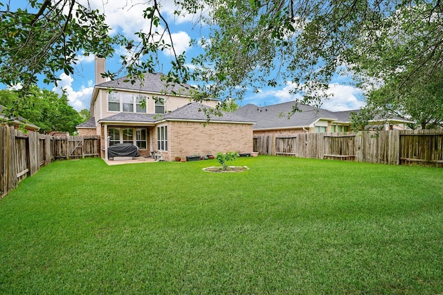 28123 Canyon Wren Dr, Katy, TX 77494 - rear view of house featuring a chimney, a fenced backyard, brick siding, a patio, and a shingled roof