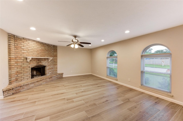 22843 Post Gate Dr, Spring, TX 77373 - unfurnished living room featuring a ceiling fan, wood finished floors, recessed lighting, and a fireplace