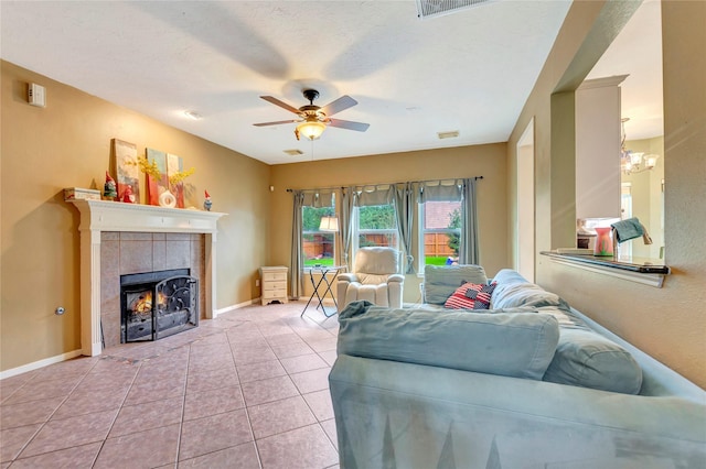 2605 Broussard Ct, Seabrook, TX 77586 - living area featuring a ceiling fan, a tile fireplace, light tile patterned floors, and a chandelier