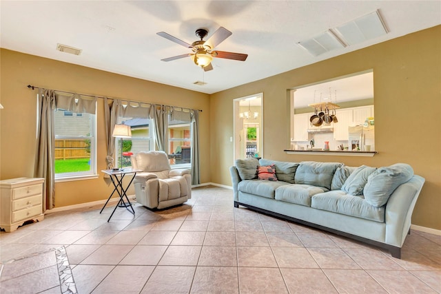 2605 Broussard Ct, Seabrook, TX 77586 - living area with ceiling fan, light tile patterned floors, and a chandelier