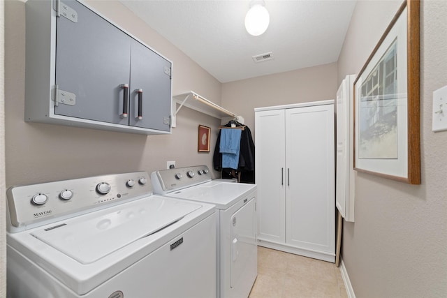 28035 Emma Gardens Ln, Spring, TX 77386 - laundry room featuring washer and clothes dryer, cabinet space, and light tile patterned floors